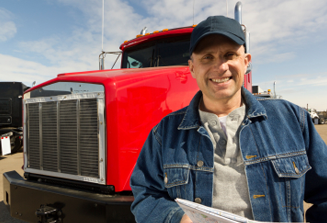 image of truck driver standing in front of red truck