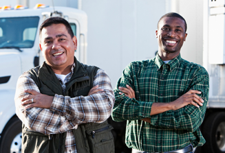 image of two smiling truckers with arms crossed standing in front of white semi