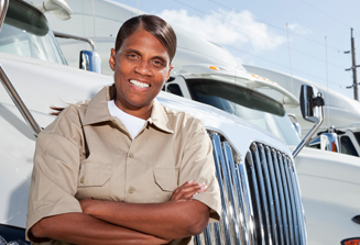 image of female truck driver leaning against white semi