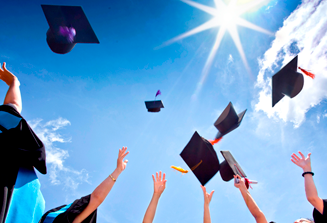 image of hands throwing graduation caps into a blue sky