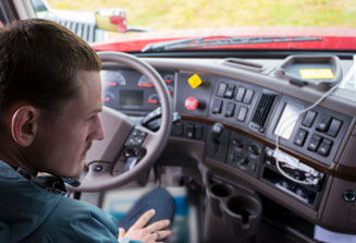 Image of a person in drivers seat of a truck
