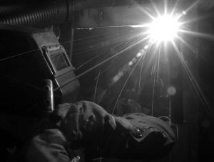 image of person welding, in black and white