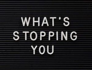 image of black letter board with the words "What's Stopping You"