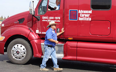 image of red ACI truck, an instructor standing next to it