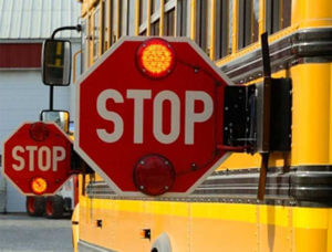 image of school bus with stop signs out
