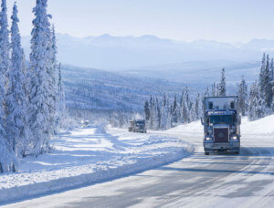 image of trucks driving on a snow-covered road