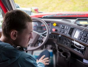 Image of man sitting in drivers seat of truck