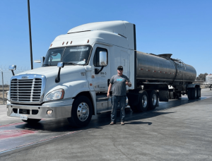 A photo of Logan in front of a tanker truck
