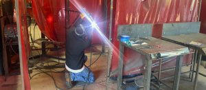 image of Advanced Career Institute Fresno's welding station with a person working